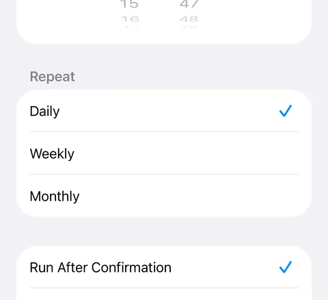 Time of Day on iOS 26 as it opens: Repeat Daily, and Run After Confirmation ticked at the very bottom of the screen, with Run Immediately hidden below it.